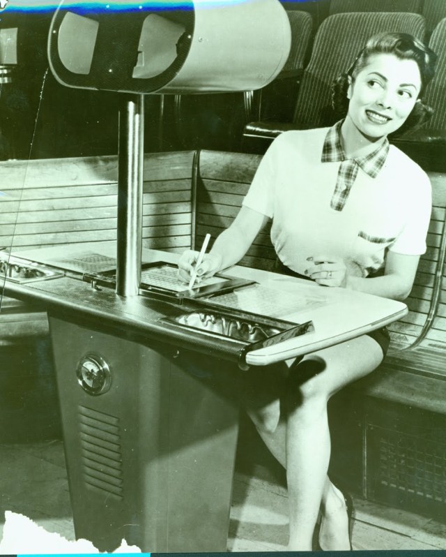 1950s vintage photo of a woman scoring a bowling game in 1950s fashion.