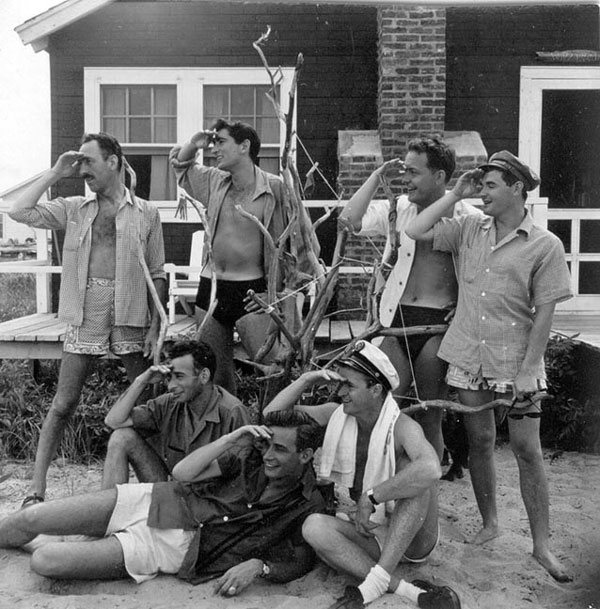 1950s vintage summer photo of men in beach fashions posing together. 
