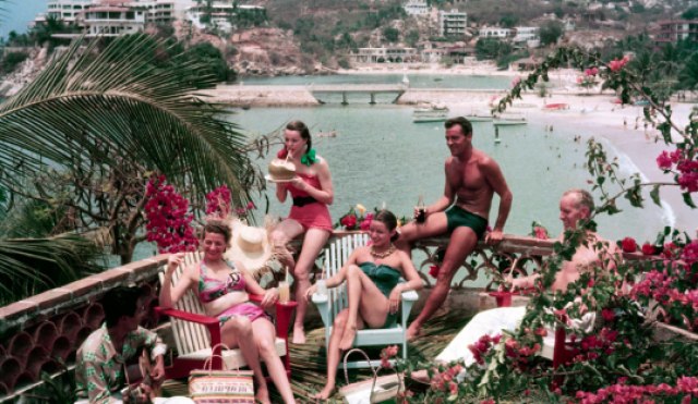 1950's of a tropical party on a balcony overlooking a beach in Mexico, Acapulco 
