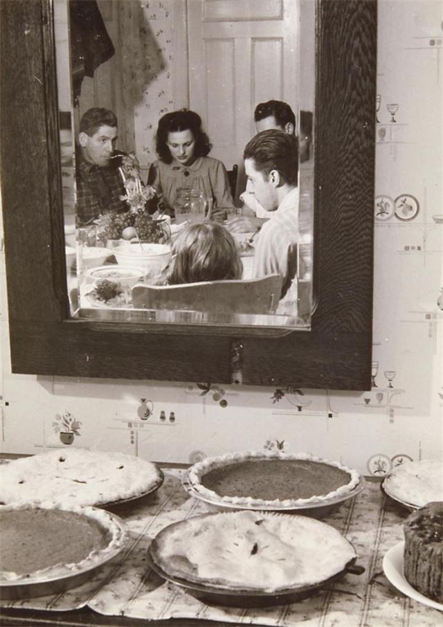 1940s vintage photo of a family enjoying their thanksgiving dinner. 