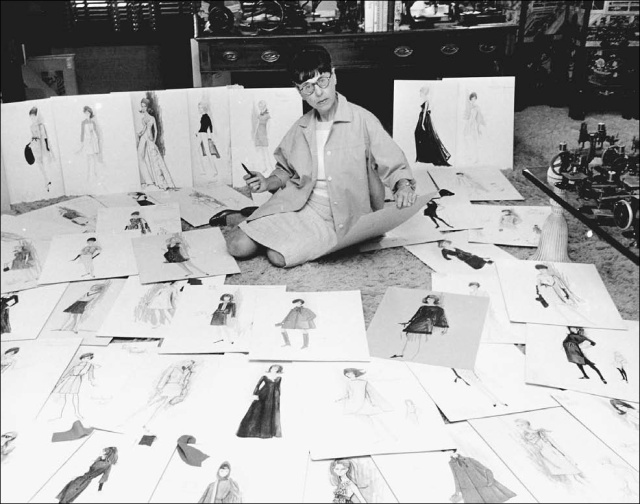 Edith head Fashion designer surrounded by her fashion design illustrations.
