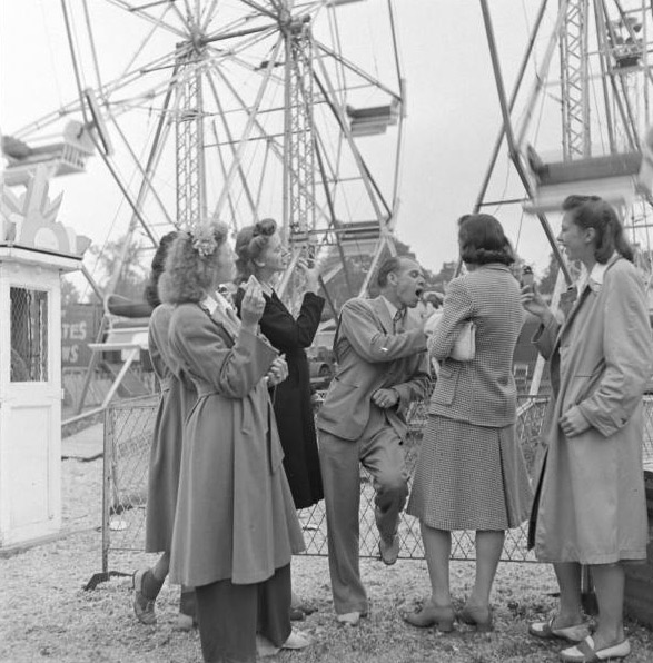 1940s vintage photo of young women in 1940s fashions posing by the ferris while with a man is from the blog post entitled..Vintage Canada: The Bill Lynch Travelling Carnival Show.