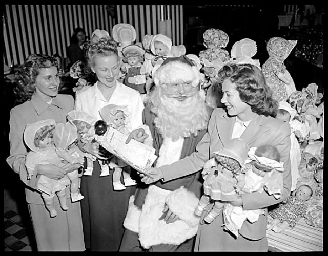 1940s vintage christmas party -1948 Attorney Generals Christmas party at Woodward’s featuring Santa with 3 women wearing 1940s hairstyles. 