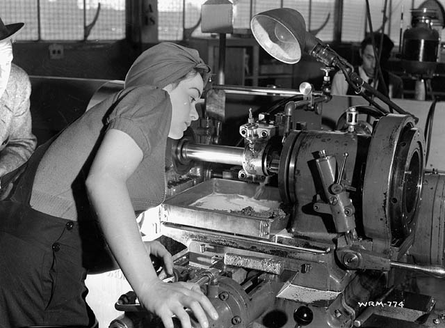 Veronica Foster-The Canadian Rosie the Riveter aka "The Bren Gun Girl". Veronica in her 1940s Homefront fashion is working on a machine. 