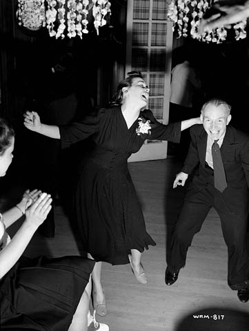 Veronica Foster-The Canadian Rosie the Riveter. 1940s Photo features Veronica in a 1940s dress dancing (doing the jitterbug / Lindy hop) at a party. 