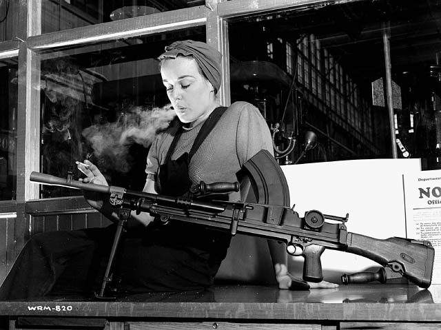 Veronica Foster-The Canadian Rosie the Riveter aka "The Bren Gun Girl". Posing for a photo with a bren gun while smoking.