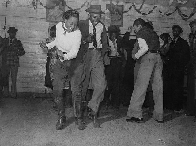 1930s/ 1940s vintage photo of a Black man and Black Woman at a Juke Joint dancing the blues or Lindy Hopper. 
