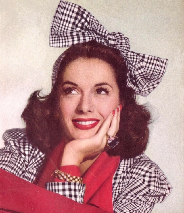 1940s vintage photo of Jinx Falkenburg the model in a 1940s hairstyle with a big bow on her head. 