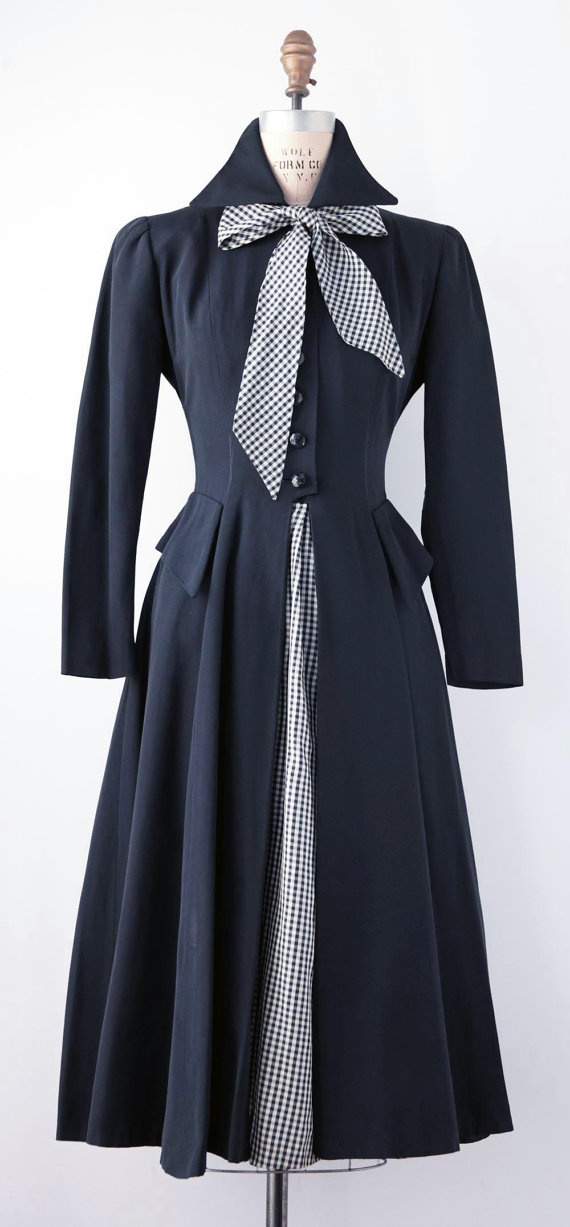 1950s Fashion: 1950's Day Dress. Navy Blue ottoman with navy and white gingham taffeta tie and skirt panel. Narrow cut sleeve with full mid calf skirt.