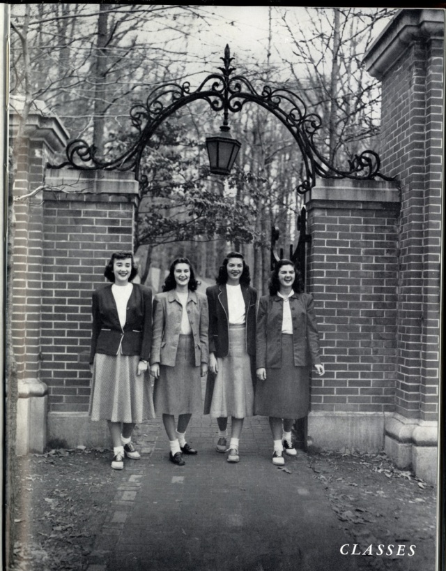 1940s Vintage Photo of 4 women in 1940s hairstyles and 1940s fashion, they are the Class Officers in front of Gate at University of Mary Washington.